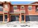 Charming townhome featuring colorful stucco facade, attached garages, and convenient front door access at 173 Villa Di Este Ter # 209, Lake Mary, FL 32746