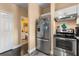 Functional kitchen featuring stainless steel appliances, wood-style floors, and a pantry space at 173 Villa Di Este Ter # 209, Lake Mary, FL 32746