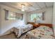 Bright bedroom featuring twin beds, neutral walls, large windows, and a ceiling fan at 203 N Forest Blvd, Lake Mary, FL 32746
