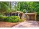 Cozy home with a screened-in porch and carport, surrounded by mature landscaping for added privacy at 203 N Forest Blvd, Lake Mary, FL 32746