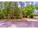 Well-maintained single-story home with mature trees and a covered carport, providing shade and curb appeal at 203 N Forest Blvd, Lake Mary, FL 32746