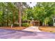 Charming single-story home with a covered carport nestled among lush green trees and landscaping at 203 N Forest Blvd, Lake Mary, FL 32746
