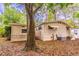 Charming home exterior featuring light siding, mature trees, and a well-maintained yard at 203 N Forest Blvd, Lake Mary, FL 32746
