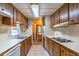 Kitchen with wood cabinetry, white appliances, and a view into the dining area, ideal for everyday living at 203 N Forest Blvd, Lake Mary, FL 32746