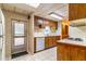 Functional kitchen featuring white appliances, wood cabinets, and a view of dining area, designed for efficiency at 203 N Forest Blvd, Lake Mary, FL 32746