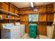 Functional laundry room with washer, dryer, and shelving for storage at 203 N Forest Blvd, Lake Mary, FL 32746