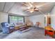 Spacious living room featuring a ceiling fan, neutral paint colors, and large windows at 203 N Forest Blvd, Lake Mary, FL 32746