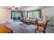 Inviting living room with neutral carpet, comfortable seating, and large windows offering natural light and views at 203 N Forest Blvd, Lake Mary, FL 32746