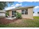 Backyard patio with lush landscaping, a seating area, and a view of the property's exterior at 2306 Valhalla Dr, Tavares, FL 32778