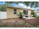 Charming backyard featuring a cozy patio area, lush greenery, and a well-maintained lawn at 2306 Valhalla Dr, Tavares, FL 32778