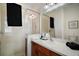 Bright bathroom featuring a glass door shower, wood cabinets, and a white countertop with a vessel sink at 2306 Valhalla Dr, Tavares, FL 32778