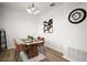 Dining room features modern light fixture, with a wooden table and accent wall art at 2306 Valhalla Dr, Tavares, FL 32778