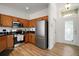 Modern kitchen with stainless steel appliances, light wood cabinets, and a bright, inviting entryway at 2306 Valhalla Dr, Tavares, FL 32778