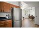 Modern kitchen featuring stainless steel refrigerator and a view into the dining area at 2306 Valhalla Dr, Tavares, FL 32778