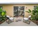 Relaxing patio space with stylish chairs, side tables, and lush plants, perfect for outdoor living at 2306 Valhalla Dr, Tavares, FL 32778