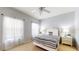 Bedroom with soft, blue walls, a ceiling fan and sunny window at 2411 Caravelle Cir, Kissimmee, FL 34746