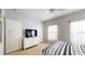 Well-lit bedroom with light blue walls, two windows, and a TV atop a dresser at 2411 Caravelle Cir, Kissimmee, FL 34746