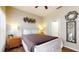 A bedroom with warm wooden floors, a comfortable bed and access to the ensuite bathroom at 2411 Caravelle Cir, Kissimmee, FL 34746