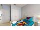 Bedroom with a twin bed, large closet and blue walls at 2411 Caravelle Cir, Kissimmee, FL 34746