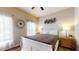 Cozy bedroom with a large bed, a ceiling fan, and bright natural light from the window at 2411 Caravelle Cir, Kissimmee, FL 34746