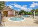 Inviting hot tub area, surrounded by pavers, lounge chairs and views of the community pool at 2411 Caravelle Cir, Kissimmee, FL 34746