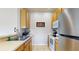 Kitchen features light wood cabinets, stainless steel appliances, and a double sink at 2411 Caravelle Cir, Kissimmee, FL 34746