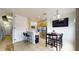 Kitchen and dining area with stainless steel appliances, breakfast bar, and an adjacent dining area at 2411 Caravelle Cir, Kissimmee, FL 34746