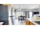 Kitchen and dining area with stainless steel appliances, light wood cabinets, and tiled floors at 2411 Caravelle Cir, Kissimmee, FL 34746