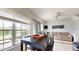 Living area with dining table, large windows with neighborhood views, and a comfortable sofa at 2411 Caravelle Cir, Kissimmee, FL 34746