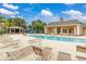 Spacious community pool area with lounge chairs, clubhouse, playground, and covered seating at 2411 Caravelle Cir, Kissimmee, FL 34746