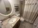 Bright bathroom featuring granite countertops and a shower-tub combination with a neutral shower curtain at 2426 Windward Way, Winter Park, FL 32792