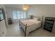 Bright bedroom with neutral walls, tile floors, and shuttered windows, offering a peaceful retreat at 2426 Windward Way, Winter Park, FL 32792
