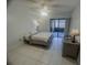 Cozy bedroom with a ceiling fan, tile floor, and sliding glass doors to an outdoor area at 2426 Windward Way, Winter Park, FL 32792