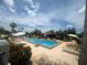 Sparkling community pool with lounge chairs and umbrellas on a sunny day at 2426 Windward Way, Winter Park, FL 32792