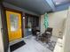 Charming front porch with seating and a bright yellow door at 2426 Windward Way, Winter Park, FL 32792