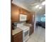 Well-equipped kitchen features a white stove, granite countertop, and wooden cabinets for a functional space at 2426 Windward Way, Winter Park, FL 32792