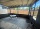 Cozy screened patio with table, chairs, and outdoor rug at 2426 Windward Way, Winter Park, FL 32792