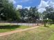 Community tennis courts surrounded by lush green trees and a brick-lined path at 2426 Windward Way, Winter Park, FL 32792