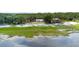 Expansive aerial view showcasing the waterfront property, lush greenery, and serene surroundings at 2518 Fort Lane Rd, Geneva, FL 32732