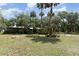Serene backyard with lush vegetation, stone landscape, and beautiful foliage at 2518 Fort Lane Rd, Geneva, FL 32732