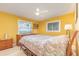 A yellow bedroom with a paisley comforter, windows, and dressers at 2518 Fort Lane Rd, Geneva, FL 32732