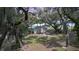 Charming home exterior featuring a lush, tree-filled yard with scenic views at 2518 Fort Lane Rd, Geneva, FL 32732