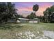 Sprawling lawn and exterior view with lush greenery and a large palm tree at 2518 Fort Lane Rd, Geneva, FL 32732