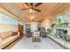 A living room with a stone fireplace, wood plank ceiling, ceiling fans, and comfortable seating at 2518 Fort Lane Rd, Geneva, FL 32732