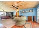 Cozy living room with wood-planked ceiling, bright blue walls and comfortable seating with views of the outdoors at 2518 Fort Lane Rd, Geneva, FL 32732