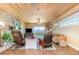 Cozy living room with a stone fireplace, comfortable seating, and beautiful waterfront views at 2518 Fort Lane Rd, Geneva, FL 32732