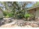 Cozy patio area with table, chairs, and stone accents, nestled among trees at 2518 Fort Lane Rd, Geneva, FL 32732