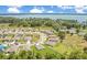 Panoramic aerial view of a charming neighborhood with lush landscaping and a lake nearby at 2668 Grand Central Ave, Tavares, FL 32778