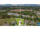 Aerial view showcasing a property's spacious yard, proximity to amenities, and community setting at 2668 Grand Central Ave, Tavares, FL 32778