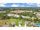 Expansive aerial shot of a community nestled among lush greenery and a tranquil lake at 2668 Grand Central Ave, Tavares, FL 32778